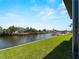A tranquil waterfront view featuring boat docks and lush green landscaping by the water's edge at 15504 Melport Cir, Port Charlotte, FL 33981