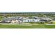 Aerial view of the clubhouse, pool, and golf course highlighting the community's amenities and landscape at 15990 Grassland Ln # 3024, Punta Gorda, FL 33982