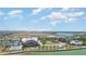 Wide aerial view of the community amenities, including a pool, lake and various community buildings at 15990 Grassland Ln # 3024, Punta Gorda, FL 33982