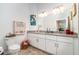 Bathroom with double vanity, granite counters, ample storage, and a well-lit mirror at 15990 Grassland Ln # 3024, Punta Gorda, FL 33982