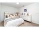 Bedroom with decorative pillows, dresser, and ample natural light creating a cozy and inviting retreat at 15990 Grassland Ln # 3024, Punta Gorda, FL 33982