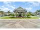 Stunning clubhouse entrance with elegant architecture, lush landscaping, and vibrant flower beds at 15990 Grassland Ln # 3024, Punta Gorda, FL 33982