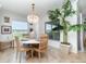 Bright dining room showcases a stylish chandelier, nautical decor, and views of the outdoors at 15990 Grassland Ln # 3024, Punta Gorda, FL 33982