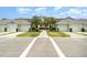 Inviting condo exterior features palm trees, well-manicured lawns, and convenient attached two-car garages at 15990 Grassland Ln # 3024, Punta Gorda, FL 33982