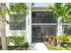 Charming condo exterior with screened-in balcony, lush tropical landscaping, and easy access to stairs at 15990 Grassland Ln # 3024, Punta Gorda, FL 33982