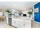 Spacious kitchen island with granite countertop overlooks the bright living area and dining space at 15990 Grassland Ln # 3024, Punta Gorda, FL 33982