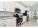 Well-equipped kitchen with stainless steel appliances, granite counters, and bright white cabinetry at 15990 Grassland Ln # 3024, Punta Gorda, FL 33982