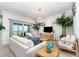 Bright living room featuring tile floors, comfortable seating, and sliding glass doors to the balcony at 15990 Grassland Ln # 3024, Punta Gorda, FL 33982