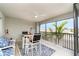 Relaxing screened patio featuring a ceiling fan, seating, and a view of the palm trees at 15990 Grassland Ln # 3024, Punta Gorda, FL 33982