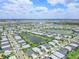 Extensive aerial view showcases this residential community with picturesque lakes and manicured landscaping under a blue sky at 17556 Winding Wood Ln, Punta Gorda, FL 33982