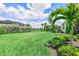 Backyard featuring well maintained lawn and professional landscaping at 17556 Winding Wood Ln, Punta Gorda, FL 33982