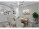 Warm dining room featuring a rustic table, six cushioned chairs, neutral rug and modern ceiling fan at 17556 Winding Wood Ln, Punta Gorda, FL 33982