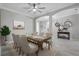 Inviting dining room with a wood table, six upholstered chairs, and a modern ceiling fan and decorative mirrors at 17556 Winding Wood Ln, Punta Gorda, FL 33982