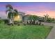 Charming front yard featuring manicured lawn, lush landscaping, and a beautifully maintained home at 17556 Winding Wood Ln, Punta Gorda, FL 33982