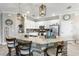 Bright kitchen with stone accent island, granite countertops, stainless appliances, and pendant lighting at 17556 Winding Wood Ln, Punta Gorda, FL 33982