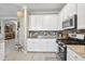 Charming kitchen featuring white cabinets, stainless steel appliances, and stylish backsplash at 17556 Winding Wood Ln, Punta Gorda, FL 33982