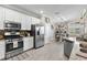 Bright kitchen with stainless steel appliances, white cabinets, granite countertops, and eat-in breakfast nook at 17556 Winding Wood Ln, Punta Gorda, FL 33982