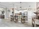 Open kitchen with granite countertop, stainless steel appliances, tile flooring, and bar stool seating at 17556 Winding Wood Ln, Punta Gorda, FL 33982
