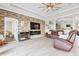 Open living room with a stone accent wall, a cozy fireplace, and stylish leather furniture at 17556 Winding Wood Ln, Punta Gorda, FL 33982