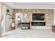 Stylish living room with stone accent wall, electric fireplace, and access to the Primary bedroom at 17556 Winding Wood Ln, Punta Gorda, FL 33982