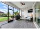 Screened-in patio featuring a grill, comfortable seating, and views of the landscaped backyard at 17556 Winding Wood Ln, Punta Gorda, FL 33982