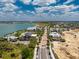Panoramic aerial view of a charming community street featuring solar panels and lake views at 17924 Corkwood Bend Trl, Punta Gorda, FL 33982