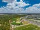 This aerial view shows baseball and soccer fields near homes and a lake at 17924 Corkwood Bend Trl, Punta Gorda, FL 33982