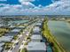 Expansive aerial view showcasing the neighborhood's beautiful homes alongside tranquil lakes and lush green spaces at 17924 Corkwood Bend Trl, Punta Gorda, FL 33982