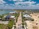 Panoramic aerial view of a charming community street featuring solar panels and lake views at 17924 Corkwood Bend Trl, Punta Gorda, FL 33982
