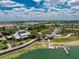 Aerial view of the community center with a pier, lake access, and lush green spaces for recreation at 17924 Corkwood Bend Trl, Punta Gorda, FL 33982