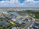 An aerial view of a Primary-planned community featuring a lake and outdoor sports complex at 17924 Corkwood Bend Trl, Punta Gorda, FL 33982