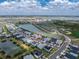 Aerial image capturing a residential home near a lake and a large outdoor sports and recreation complex at 17924 Corkwood Bend Trl, Punta Gorda, FL 33982
