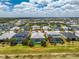 Aerial view of a single-Gathering home with a screened-in pool overlooking a picturesque pond at 17924 Corkwood Bend Trl, Punta Gorda, FL 33982