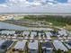 Wide aerial view showcasing a vibrant community near a lake and an extensive sports complex at 17924 Corkwood Bend Trl, Punta Gorda, FL 33982