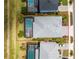 Aerial view of a home with a screened-in pool, complemented by lush landscaping and a grey shingle roof at 17924 Corkwood Bend Trl, Punta Gorda, FL 33982