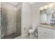 Bathroom featuring tiled shower with glass door, granite vanity, and neutral color palette at 17924 Corkwood Bend Trl, Punta Gorda, FL 33982