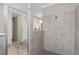 Beautifully tiled bathroom with a glass shower and a glimpse into the rest of the space at 17924 Corkwood Bend Trl, Punta Gorda, FL 33982