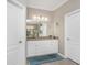 Bathroom featuring a granite vanity, a large mirror, and modern lighting, offering a refreshing aesthetic at 17924 Corkwood Bend Trl, Punta Gorda, FL 33982