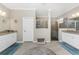 Luxurious bathroom with dual granite vanities, a glass-enclosed shower, and stylish decor at 17924 Corkwood Bend Trl, Punta Gorda, FL 33982