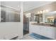 Contemporary bathroom featuring a glass-enclosed shower and a granite-topped vanity with modern fixtures at 17924 Corkwood Bend Trl, Punta Gorda, FL 33982