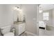 Bathroom featuring tiled granite vanity, neutral color palette, with an open view to the bedroom at 17924 Corkwood Bend Trl, Punta Gorda, FL 33982