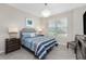 Cozy bedroom featuring neutral walls, a ceiling fan and a bright sunny window at 17924 Corkwood Bend Trl, Punta Gorda, FL 33982