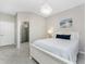 Comfortable bedroom with neutral walls, nice chandelier, a bright sunny window and a view of the bathroom at 17924 Corkwood Bend Trl, Punta Gorda, FL 33982