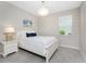 Comfortable bedroom with neutral walls, nice chandelier, and a bright sunny window at 17924 Corkwood Bend Trl, Punta Gorda, FL 33982