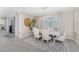 Elegant dining room with modern chandelier, neutral décor, and access to the lanai at 17924 Corkwood Bend Trl, Punta Gorda, FL 33982