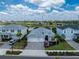 A three-car garage home with manicured landscaping and a paved driveway in a suburban neighborhood at 17924 Corkwood Bend Trl, Punta Gorda, FL 33982