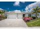 Charming one-story home featuring a two-car garage, lovely landscaping, and a brick paved driveway at 17924 Corkwood Bend Trl, Punta Gorda, FL 33982