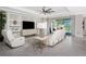 Bright living room featuring modern furniture, stylish decor, and large sliding doors to the patio at 17924 Corkwood Bend Trl, Punta Gorda, FL 33982