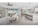 Open-concept living space with kitchen bar, dining area, and access to screened outdoor space at 17924 Corkwood Bend Trl, Punta Gorda, FL 33982