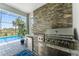 The outdoor grill features a stone facade and a built-in mini refrigerator at 17924 Corkwood Bend Trl, Punta Gorda, FL 33982